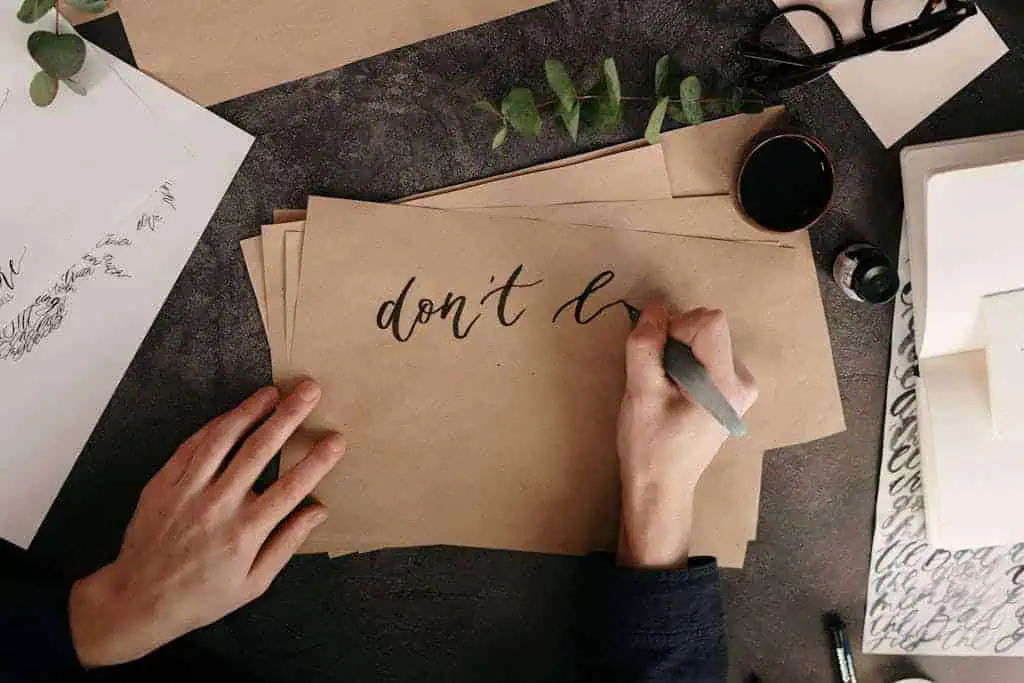 Person Writing on Brown Envelope